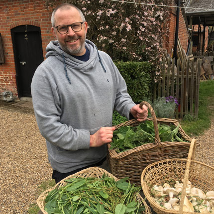 Chef holding baskets of local produce